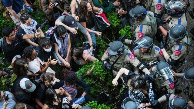 Lines of potestors and state police meet at the University of Texas Austin 