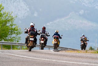 Image of Three Motorcyle Riders with One in the Lead