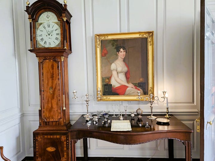 Colonial rooms with walls painted blue and wooden floors.