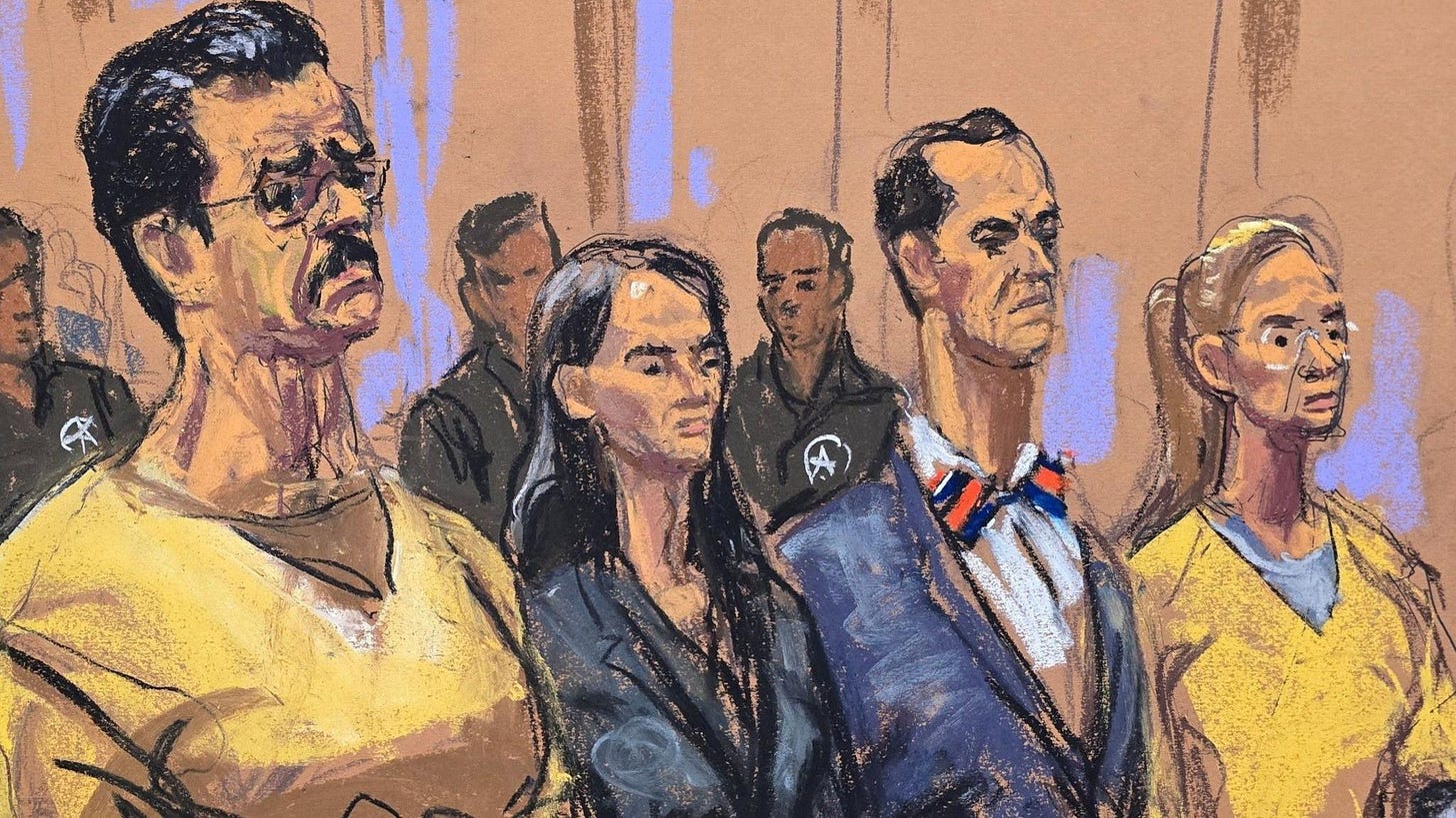 A sketch from court shows Nicolas Maduro and wife Cilia Flores standing with their lawyers between them. They are in prison uniforms and their lawyers, a woman and a man, are in suits.
A sketch from court shows Nicolas Maduro and wife Cilia Flores standing with their lawyers between them. They are in prison uniforms and their lawyers, a woman and a man, are in suits.