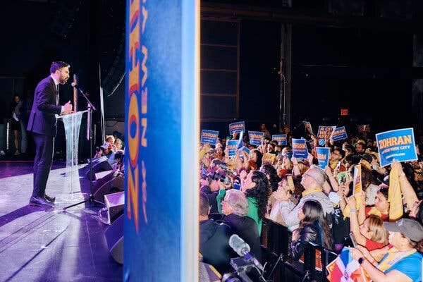 Zohran Mamdani speaks from a stage to a crowd in Brooklyn during his mayoral campaign.
