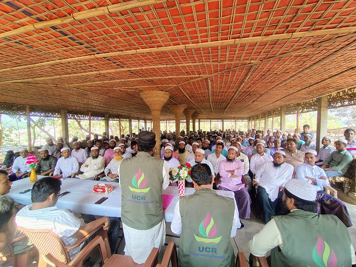 packed hall attends a United Council of Rohingya (UCR) meeting in the camps. 
