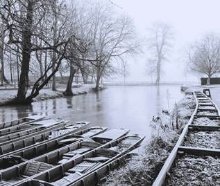 A monochrome photograph of punts on a river in Oxford in winter, covered in ice. Taken by Erica Longfellow. A monochrome photograph of punts on a river in Oxford in winter, covered in ice. Taken by Erica Longfellow.