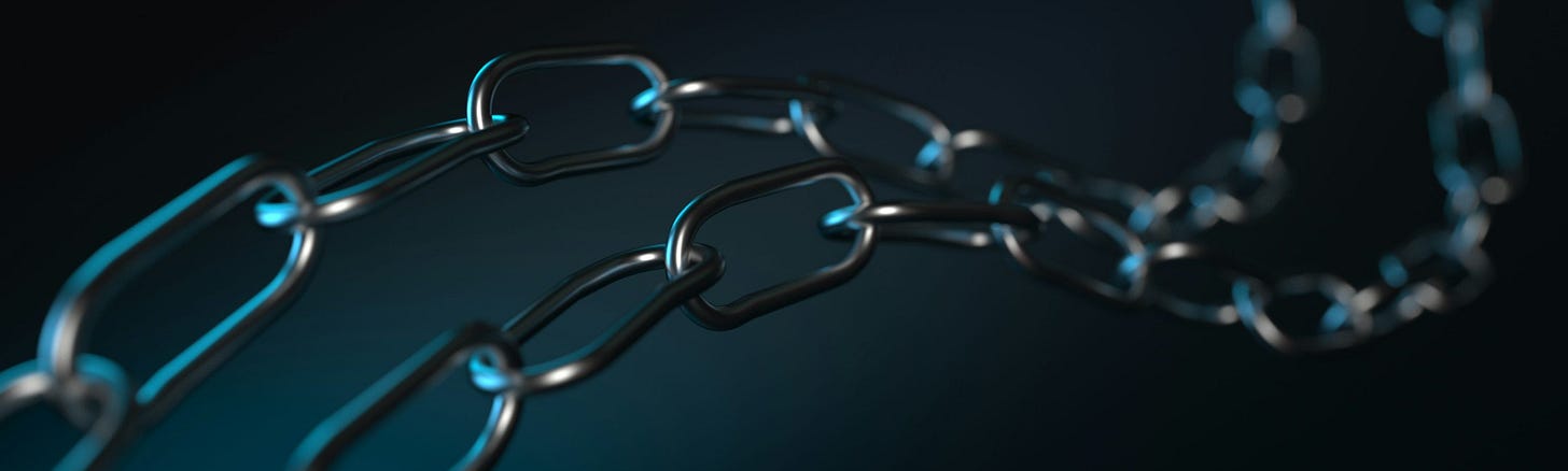 A metallic chain against a dark background