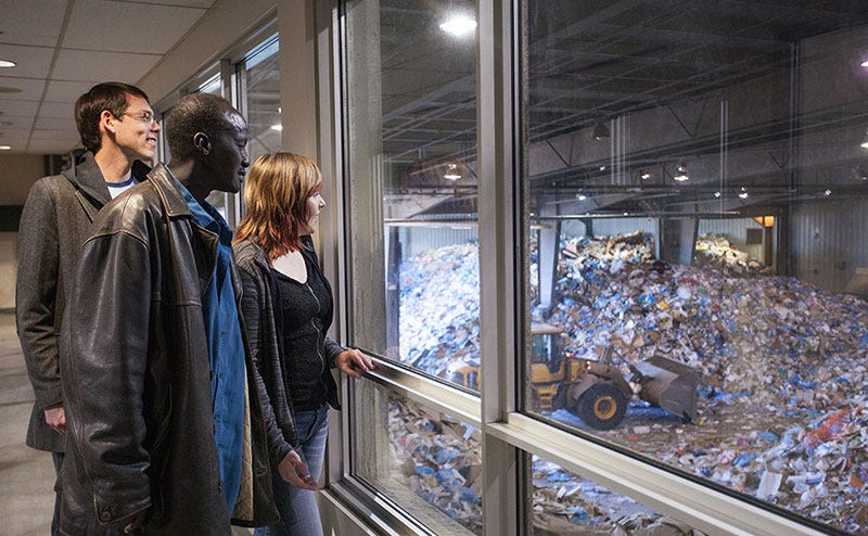 Visitors observe waste-handling operations through a viewing window at the Edmonton Waste Management Centre Visitors observe waste-handling operations through a viewing window at the Edmonton Waste Management Centre
