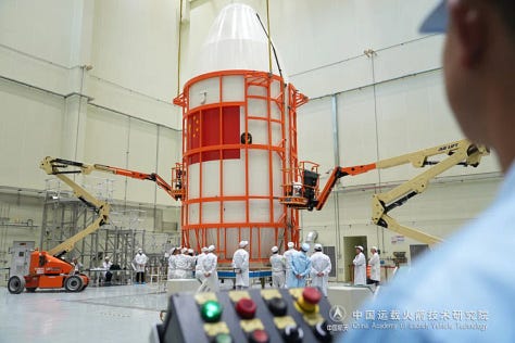 The Long March 2C's fairing being prepared for and lifted onto the launch pad as well as the second-stage.