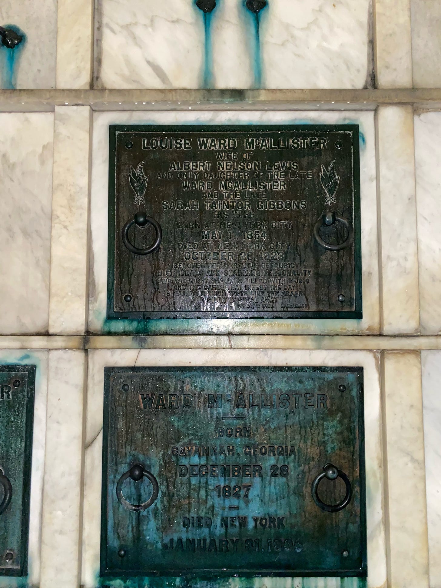 Two crypts in Green-Wood. The high slab is engraved for Louise Ward McAllister. The lower one is Ward McAllister. Both are metal that have been worn down by liquid because the whole wall is mysteriously damp and dripping and if you believe in ghosts, it's probably Caroline Astor's revenge for his telling tales out of school. Two crypts in Green-Wood. The high slab is engraved for Louise Ward McAllister. The lower one is Ward McAllister. Both are metal that have been worn down by liquid because the whole wall is mysteriously damp and dripping and if you believe in ghosts, it's probably Caroline Astor's revenge for his telling tales out of school.