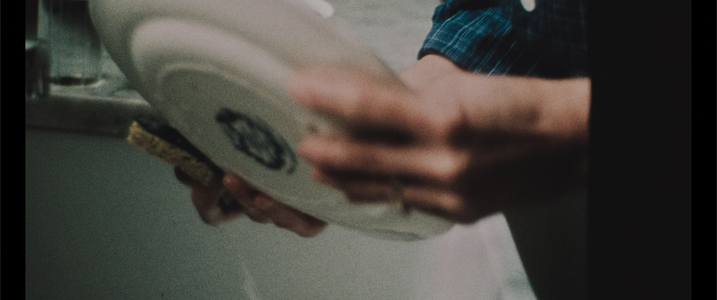 Mark doing the dishes in the flashback