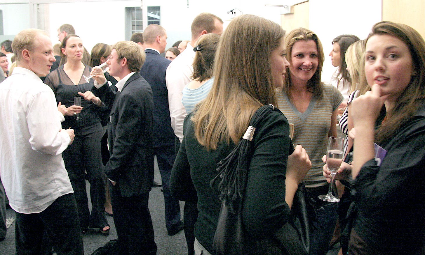 A photo of people celebrating at a launch party from Nile's past, where everyone looks significantly younger than they are now.
