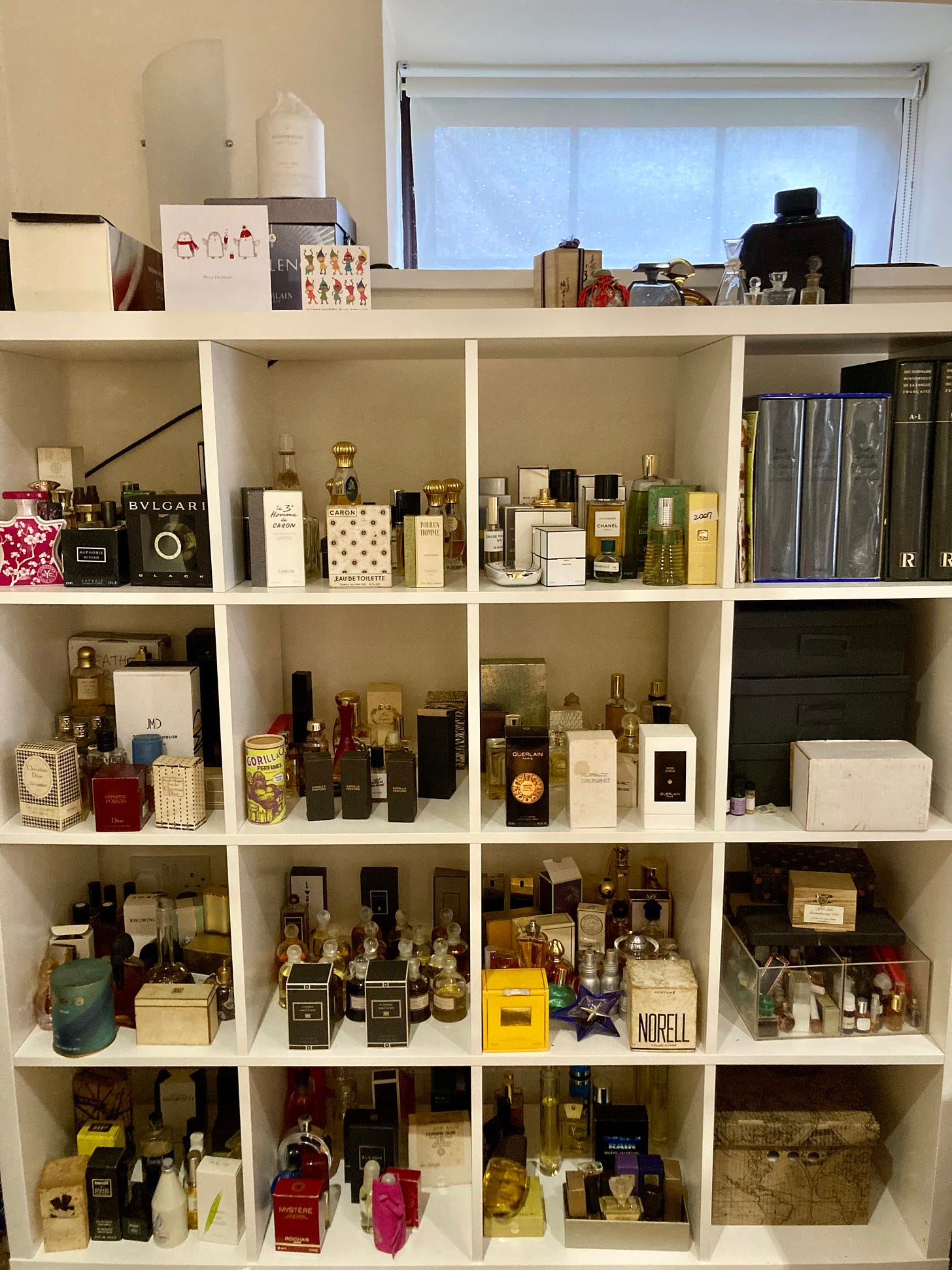 A large bookcase full of perfume bottles