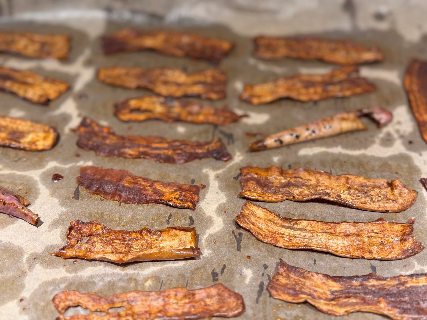 eggplant bacon strips on parchment