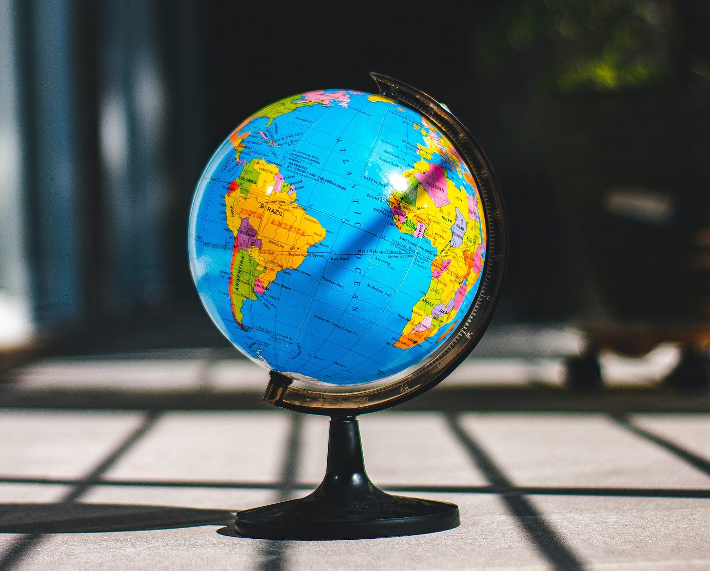A globe sitting in the sun centered on the Atlantic ocean.