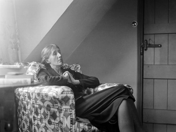 This may contain: a woman sitting on top of a chair in a living room