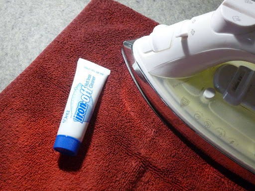 cleaning your iron with a cloth and a product