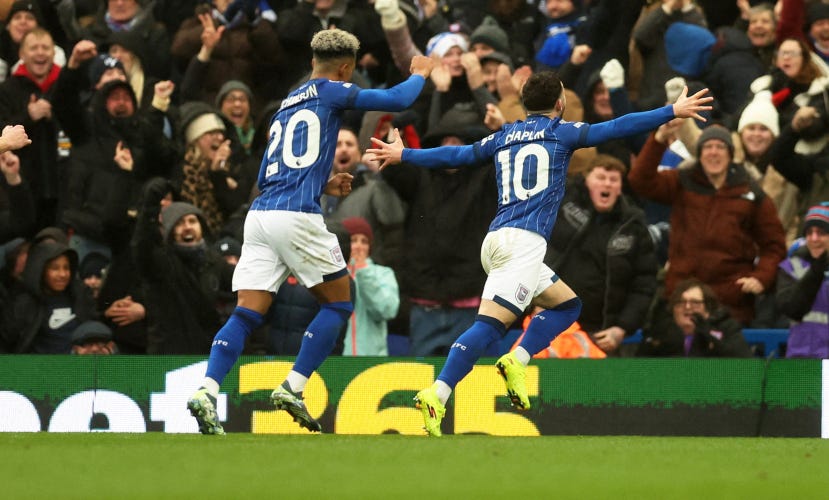 Conor Chaplin celebrates opening the scoring against Bournemouth, Omari Hutchinson is chasing him, behind him fans celebrate