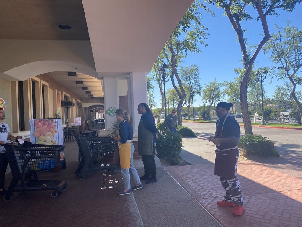 3 people standing in front of a super market