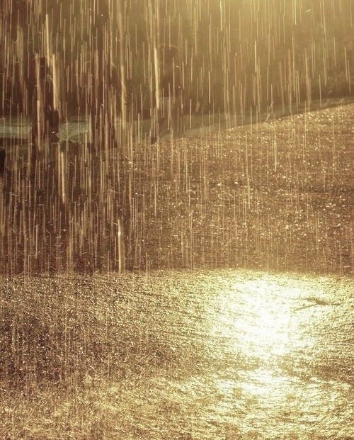 This may contain: the sun is shining down on some water and it's raining in the rain
