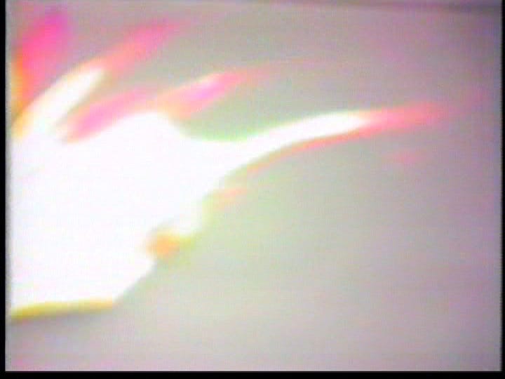 hand gestures grow so rapid and distorted that they cease to be legible as hands and fingers and instead become bright white flashes of light