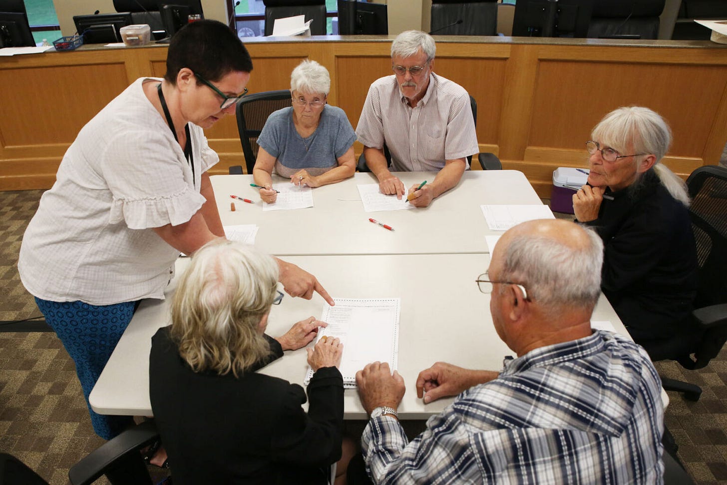 Lincoln County Auditor Sheri Lund (left) oversees election workers conducting the county's first-ever post-election audit on June 20, 2024. (Makenzie Huber/South Dakota Searchlight)