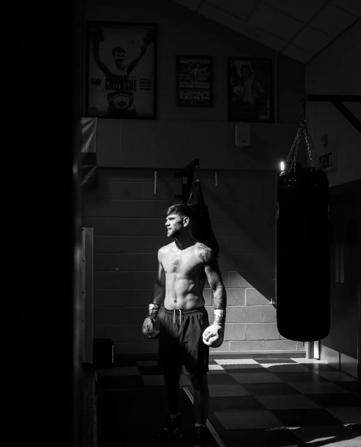 Joe Cordina is lit up in a dark boxing gym.