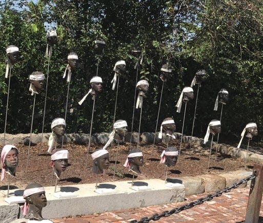 A group of heads with heads on poles

Description automatically generated