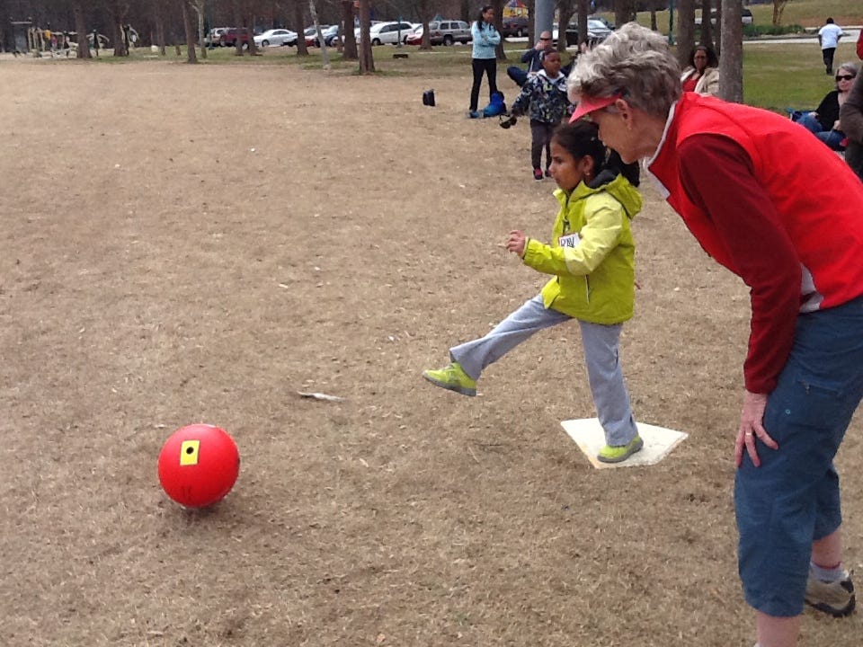 Child kicking a beep kickball