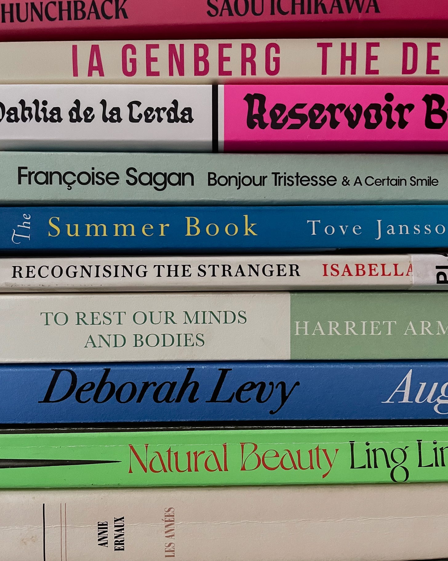 close-up of colourful book spines from my august tbr