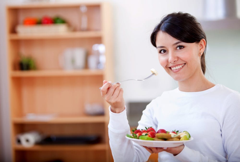 Healthy eating woman with fruit salad smiling Healthy eating woman with fruit salad smiling