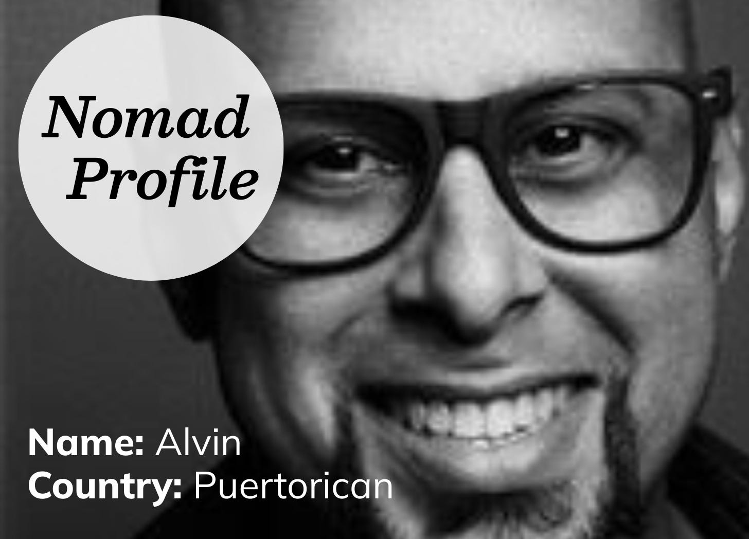 Black and white close-up photograph of a Latino man. He has thick-black rimmed glasses, with a bald head, goatee, and big smile. Black and white close-up photograph of a Latino man. He has thick-black rimmed glasses, with a bald head, goatee, and big smile.