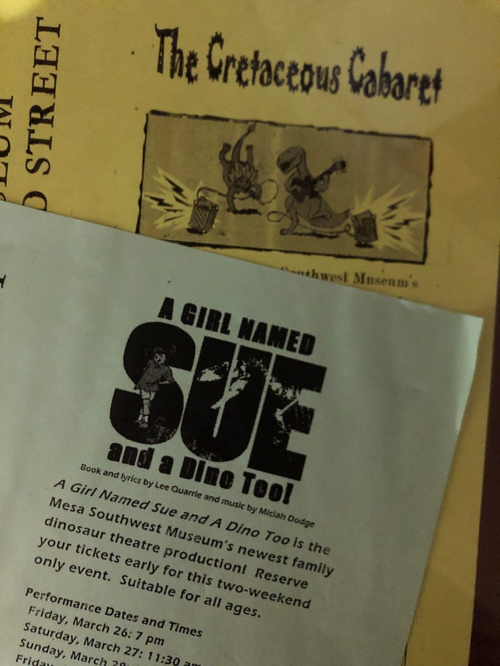 Flyers for two dinosaur musicals and a business card w name in Japanese.