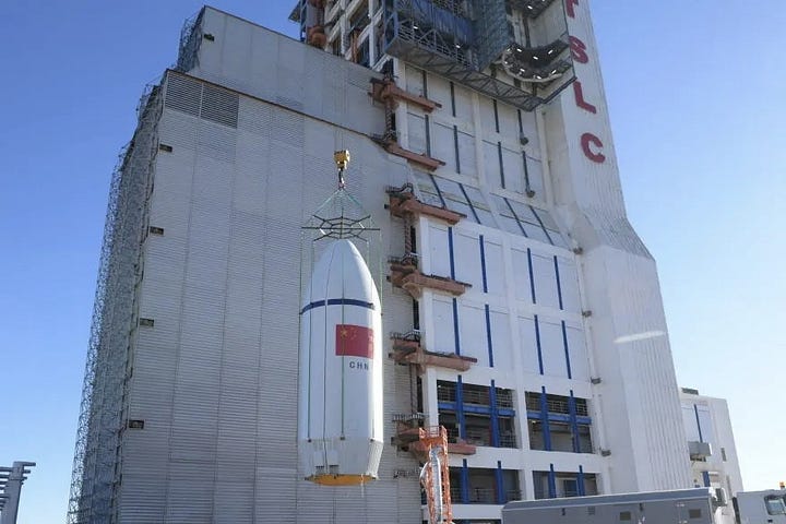 The fairing for the Long March 6A Y15 vehicle being transported to and lifted onto the launch pad.