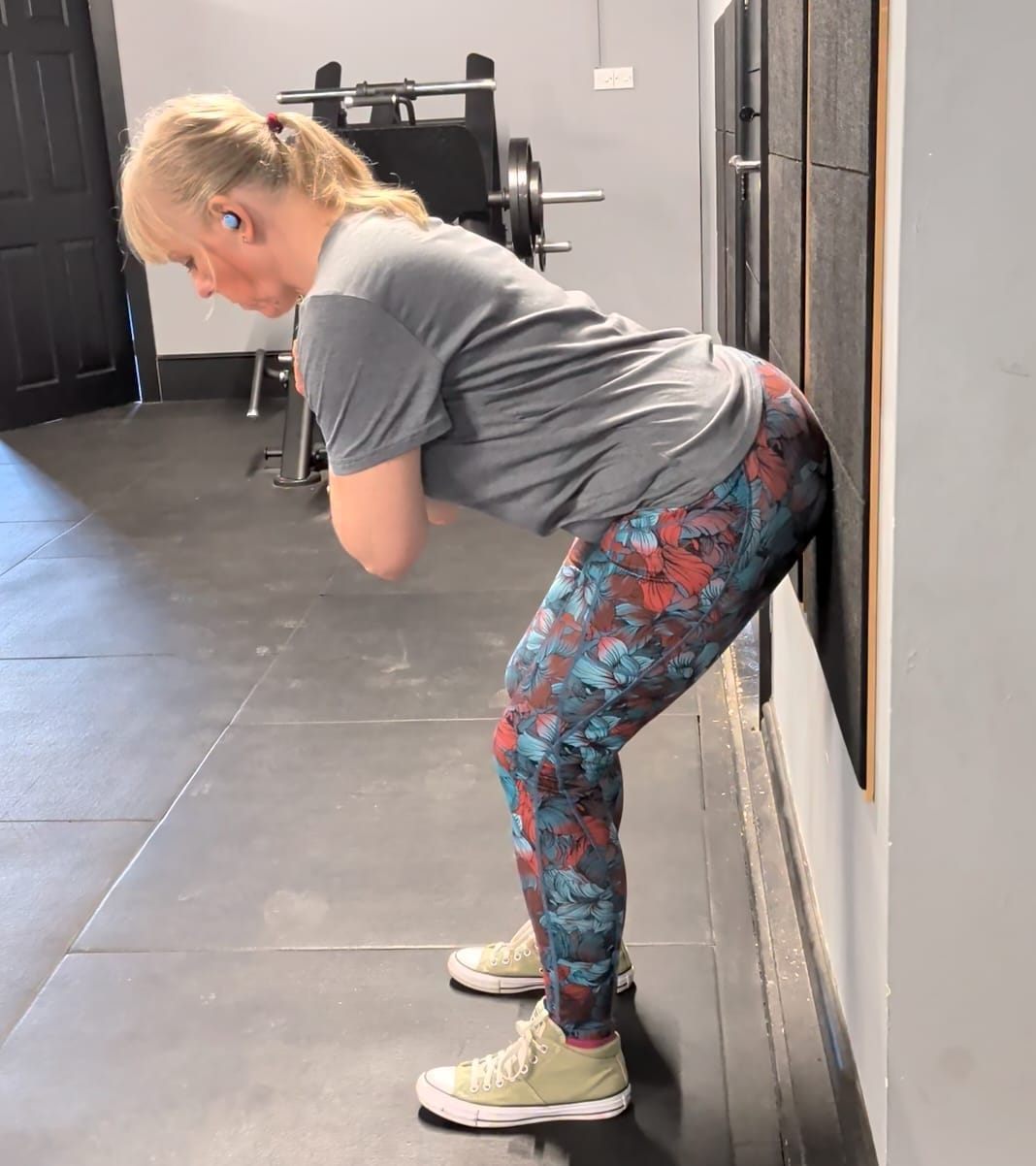 Andrea demonstrating a wall hinge exercise