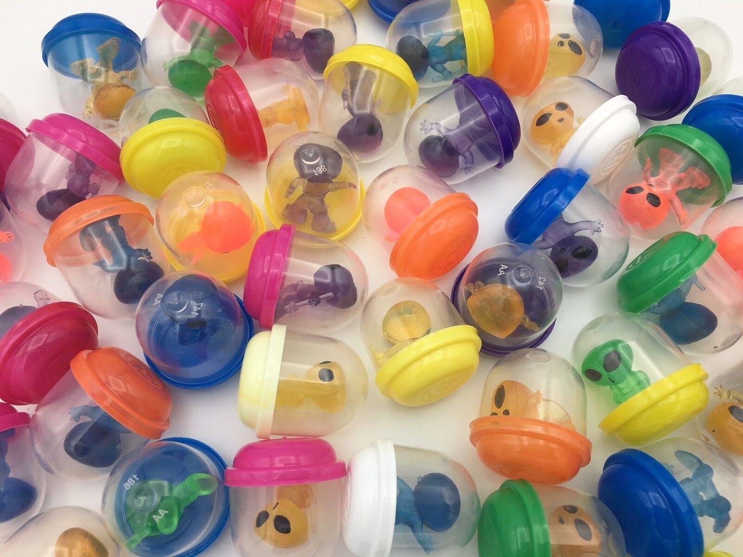 Little alien vending machine capsule dudes.