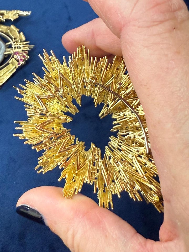 Melanie Grant, Jo McAllister looking at back of GRIMA gold and diamond brooch and pendant