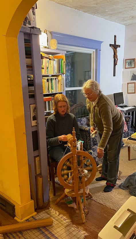 People sewing and spinning as they learn crafts.