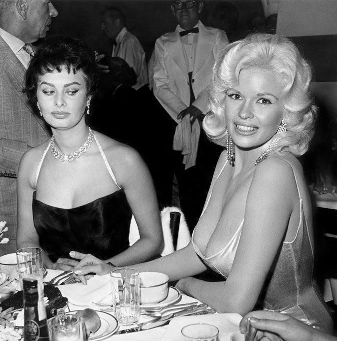 Sophia Loren side-eyeing Jayne Mansfield's low cut dress at a party thrown  in honor of Loren's arrival to Hollywood by Paramount Studios, 1957 :  r/classicfilms