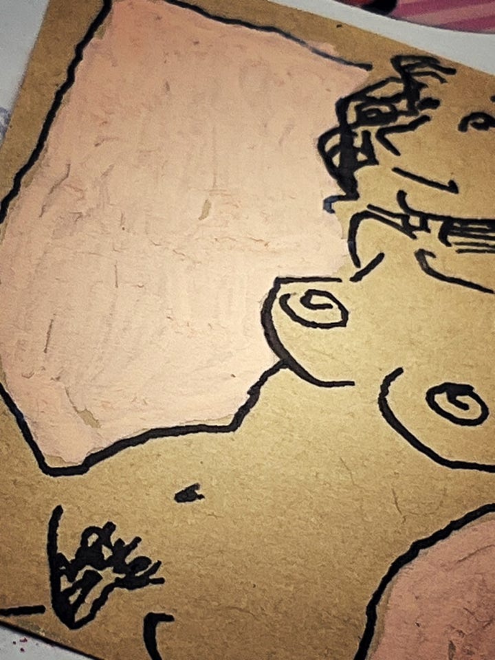 A split image displaying two close-up views. The left panel shows an open page of an artist's scrapbook featuring a detailed ink sketch on a pinkish paper slip of a reclining female figure. The right panel is an extreme close-up of the textured paper, emphasizing the fine ink line work and brush strokes on the sketch's background.