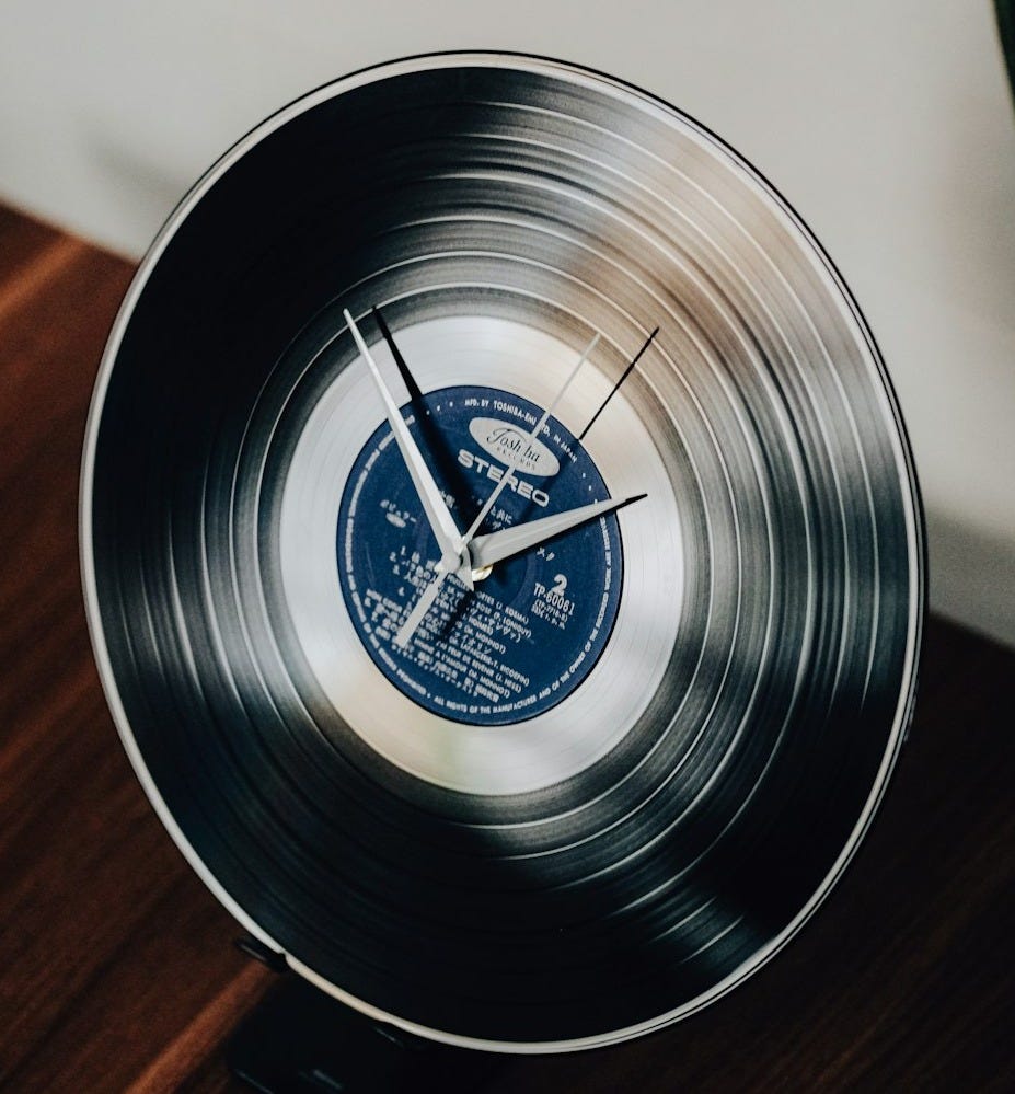 A clock made from a vinyl record A clock made from a vinyl record