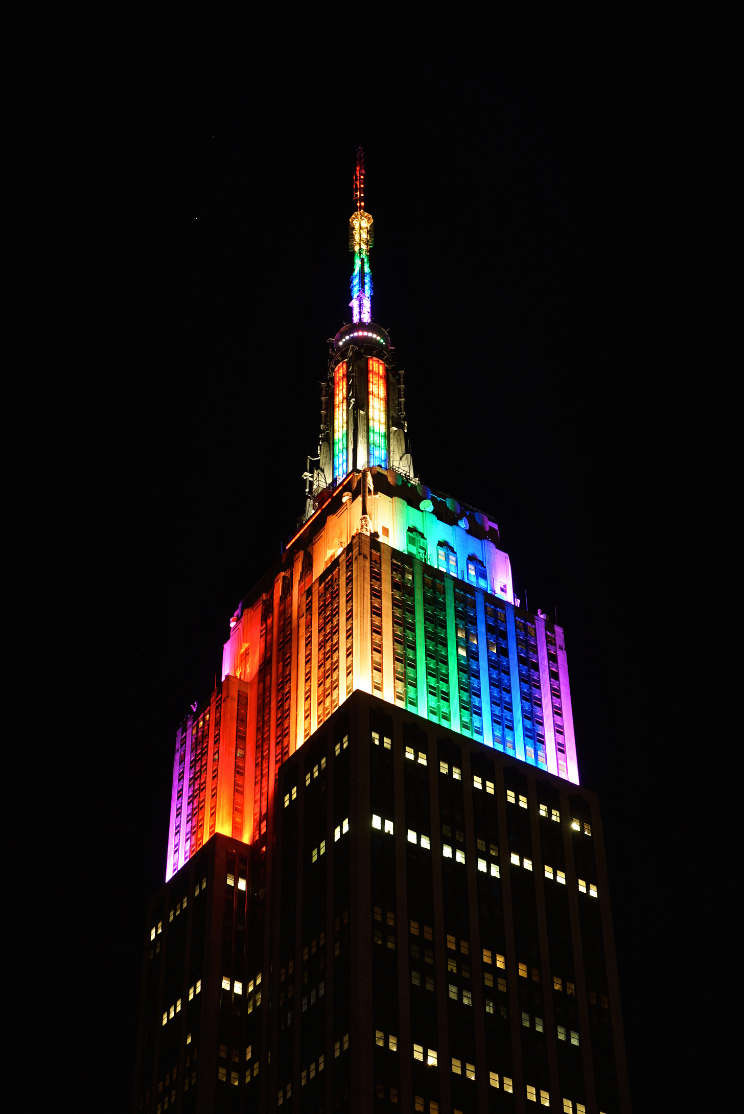 Photo of Empire State Building at night lit in Rainbow lights