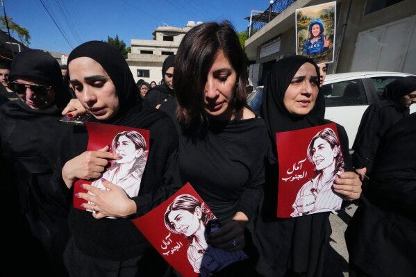 Mourners hold posters that show portraits of Lebanese journalist Amal Khalil, who was killed Wednesday in an Israeli airstrike, during her funeral procession in the village of Baysariyeh in southern Lebanon on Thursday, April 23, 2026. (AP Photo/Mohammed Zaatari) Mourners hold posters that show portraits of Lebanese journalist Amal Khalil, who was killed Wednesday in an Israeli airstrike, during her funeral procession in the village of Baysariyeh in southern Lebanon on Thursday, April 23, 2026. (AP Photo/Mohammed Zaatari)