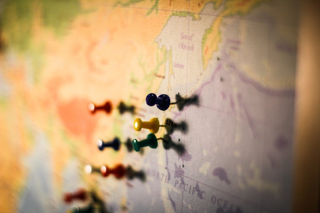 selective focus photography of push pin in map selective focus photography of push pin in map