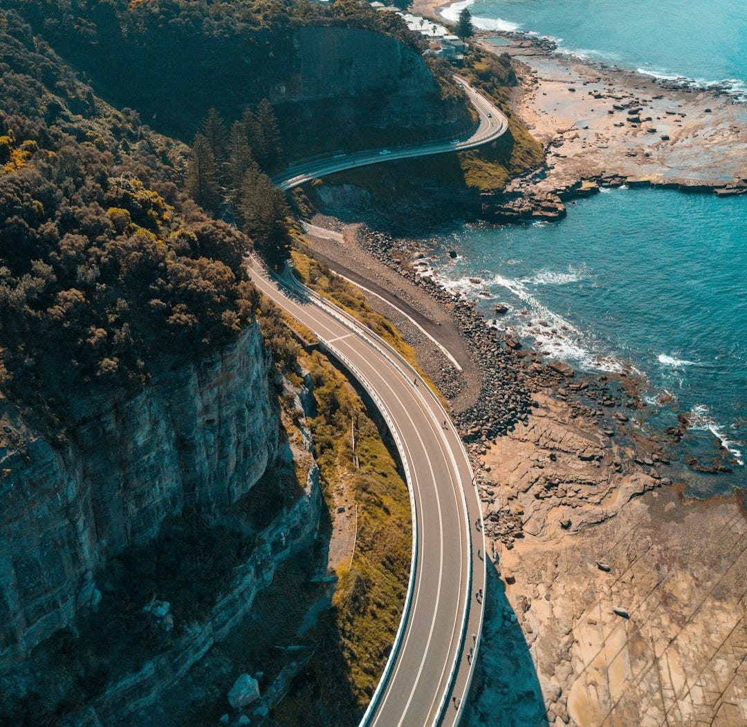 birds eye view of highway beside bay birds eye view of highway beside bay