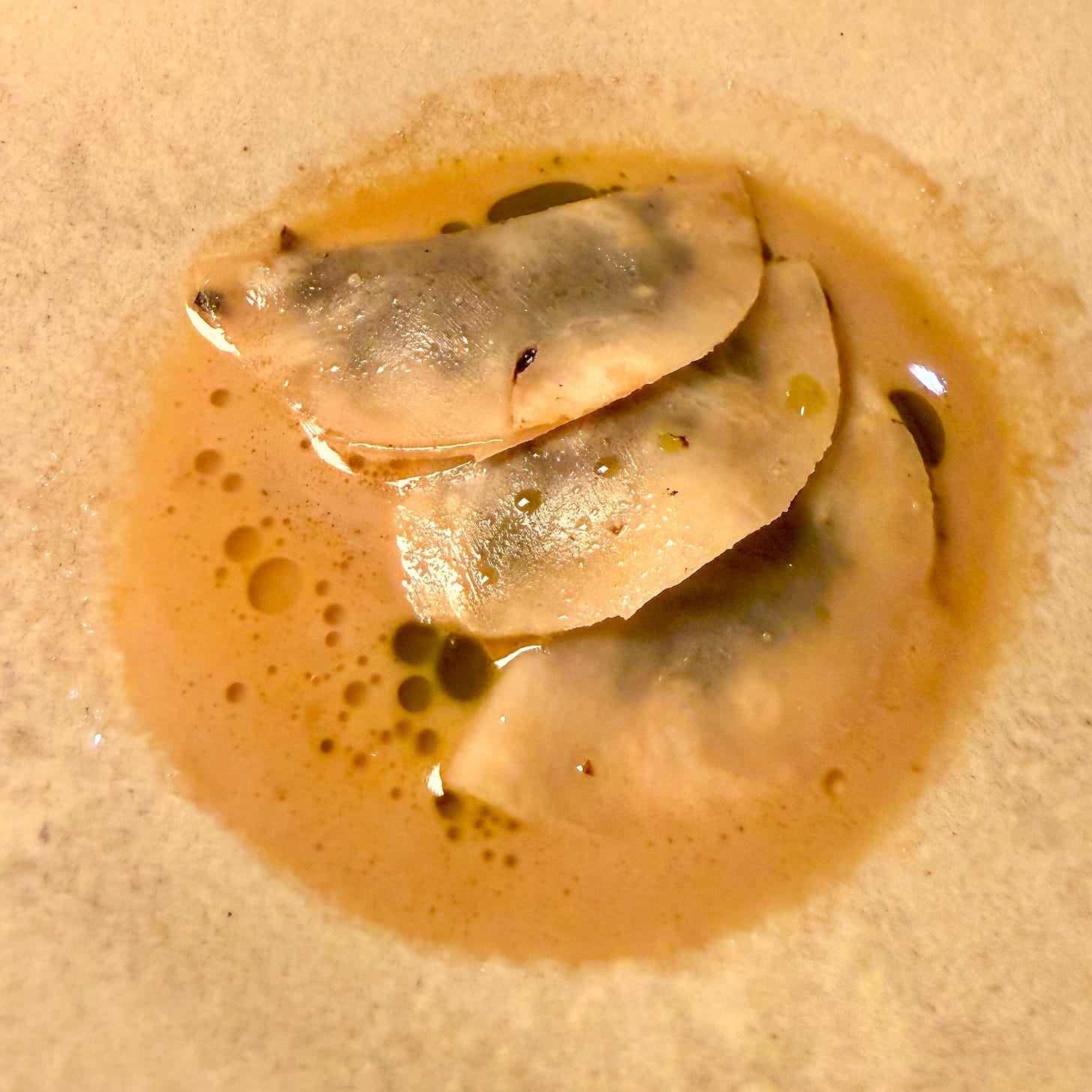 Celeriac raviole with kalamata olives and white truffle jus at Masaikuta, Paris 11th
