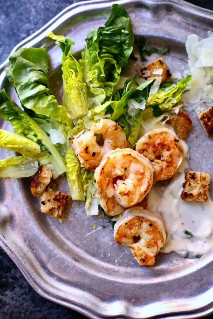 a silver platte with a shrimp salad on it. a silver platte with a shrimp salad on it.