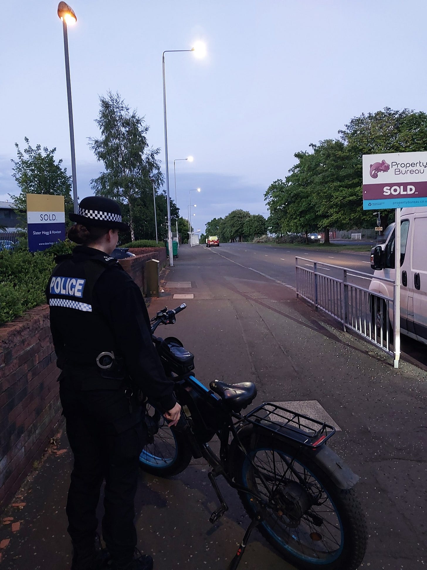 A police officer is carrying out checks on an E-bike as part of a road safety day of action in Greater Glasgow Division.