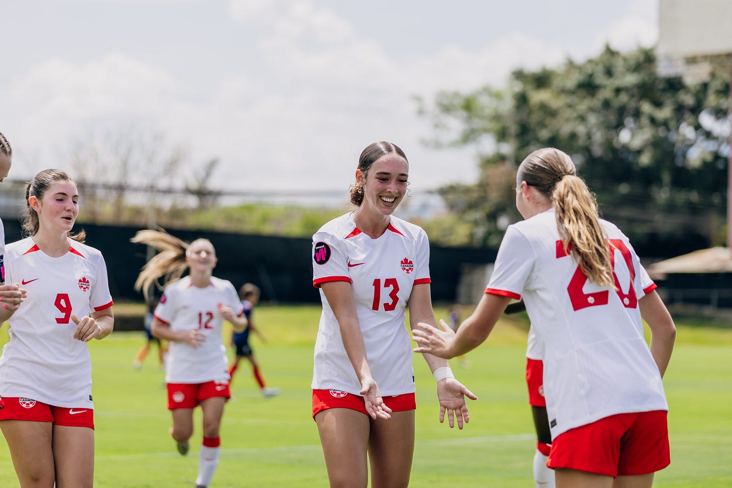 Canadian players celebrate one of their seven goals against Dominican Republic