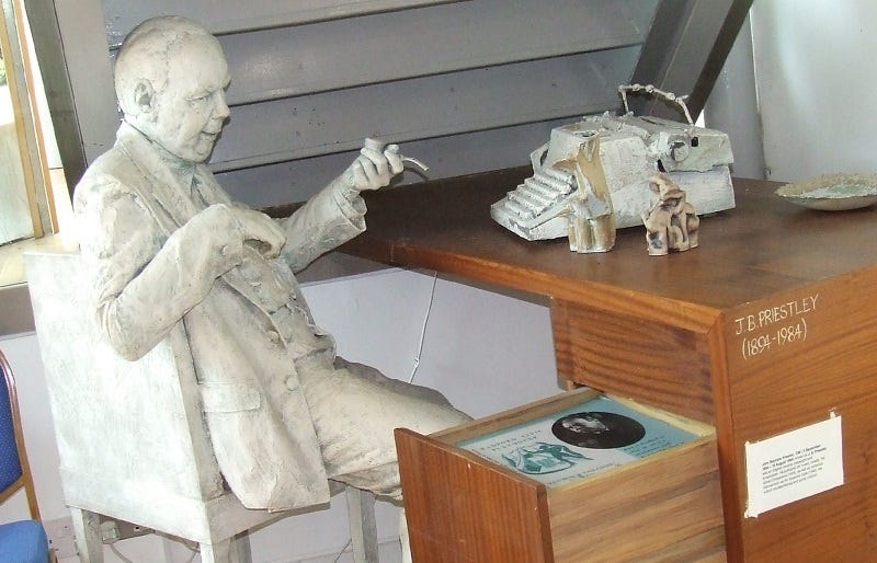 a statue of J B Priestley holding his trademark pipe.