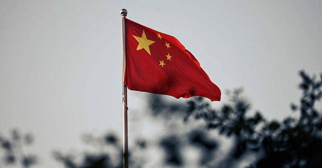 A chinese flag waves against a cloudy sky. A chinese flag waves against a cloudy sky.