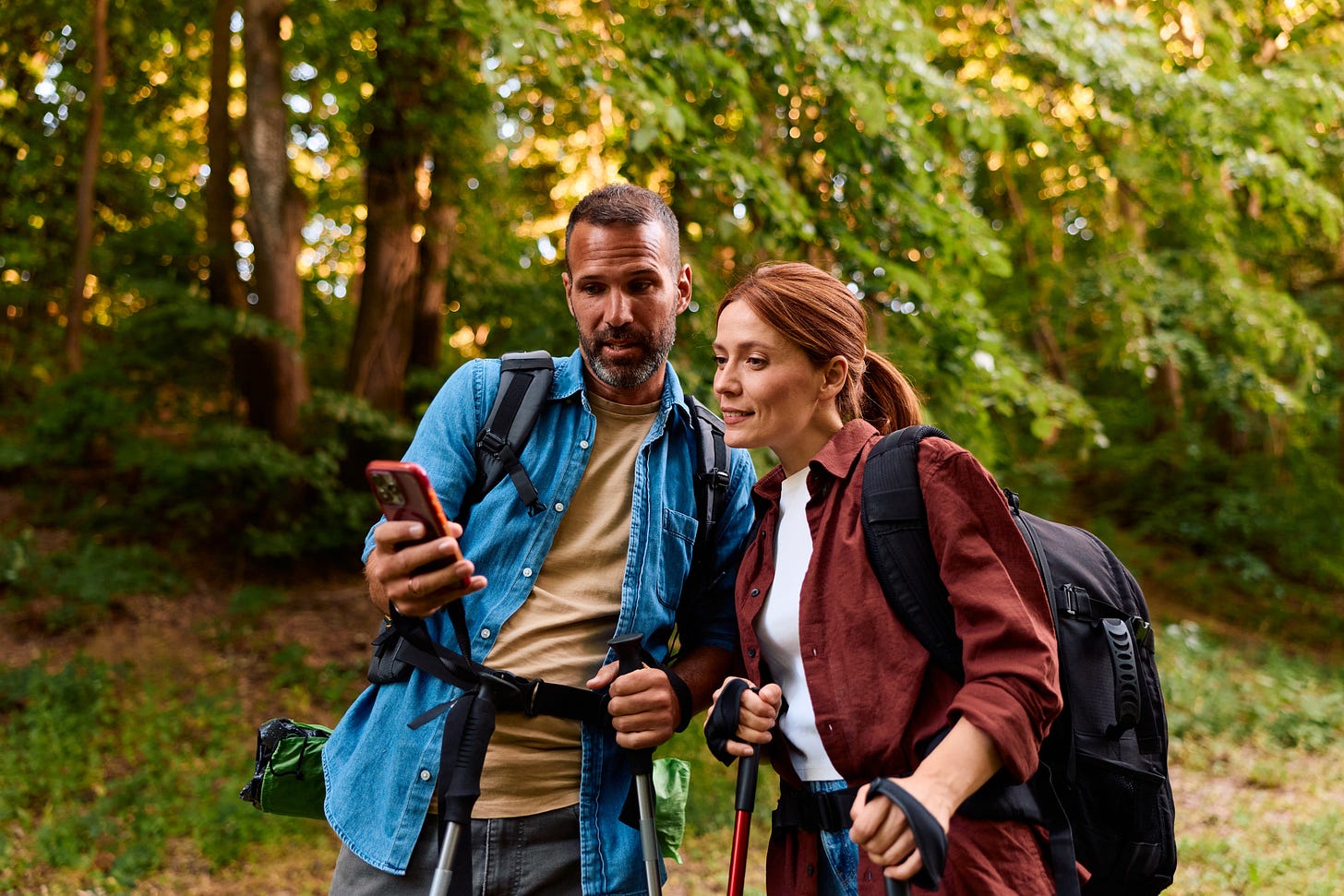 Couple on a hike using a smartphone to navigate