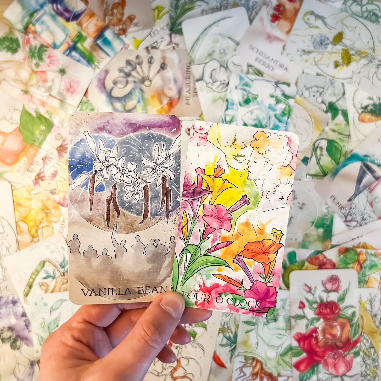 Two cards from the Apothecary Spirits Oracle decks, against a background of all other cards in the deck.